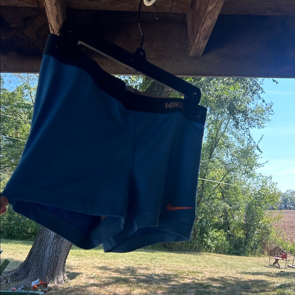 Nike Blue Shorts with Black Waistband and Orange Logo